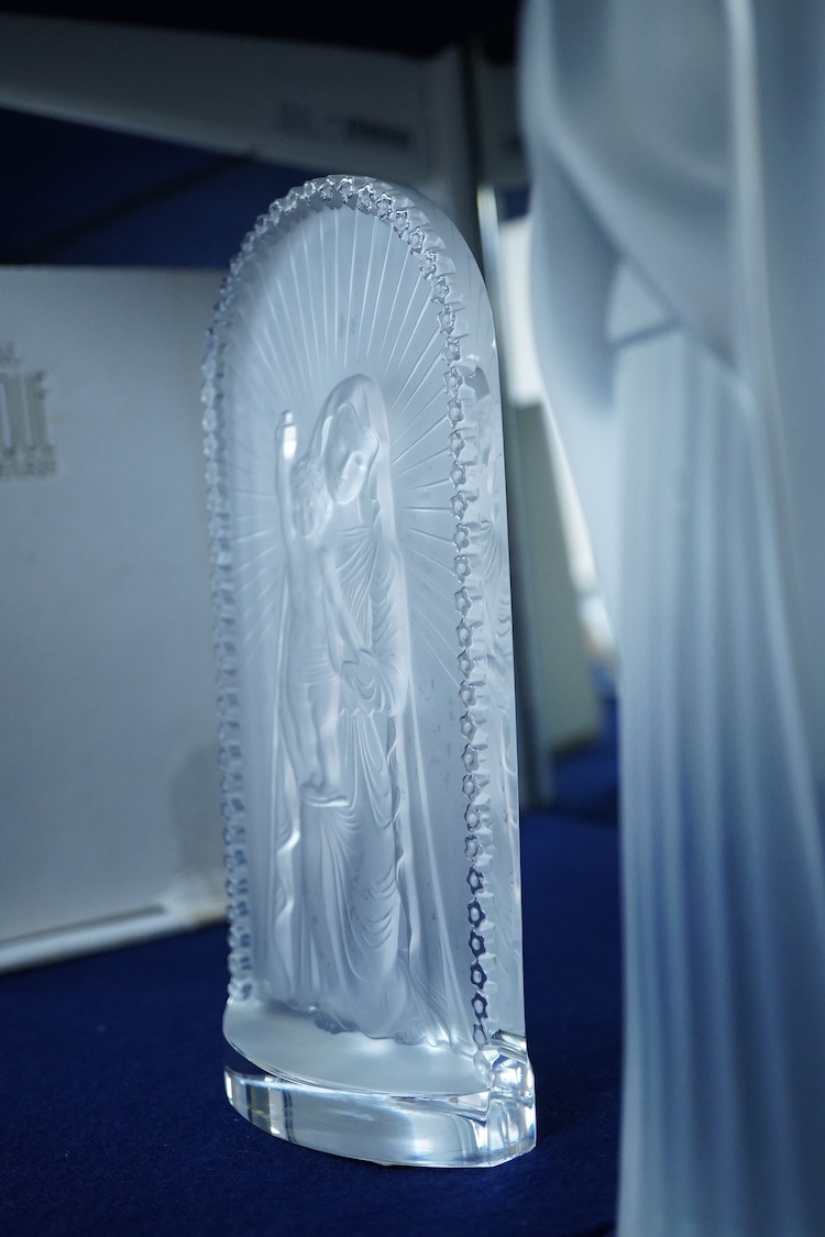 A Lalique ‘Vierge A L’Enfant Agenouille statue’ 20cm high, together with a model of ‘Virgin with hands together’, 25cm high (both boxed)